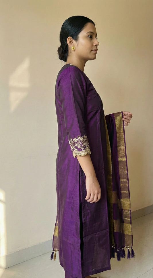 Woman in a purple kurti with gold embroidery and a matching gold-bordered dupatta