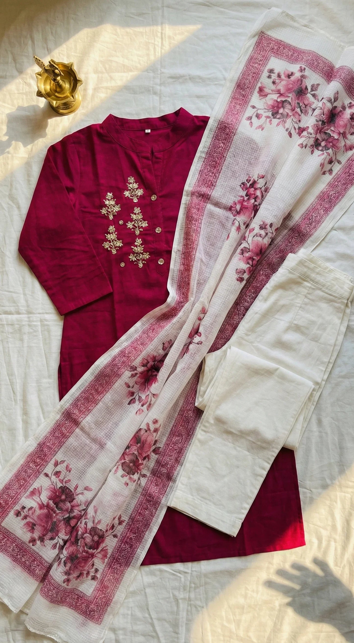 Maroon kurti with floral embroidery, paired with white pants and a floral printed dupatta.